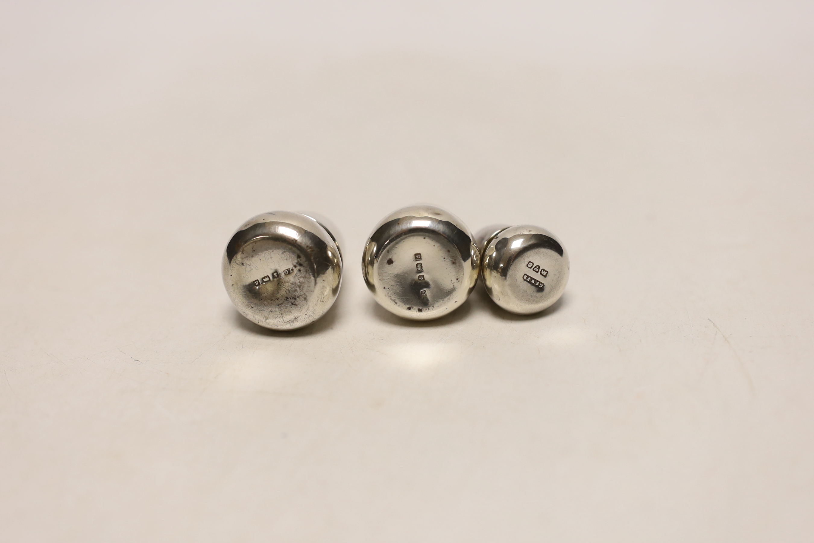 Two pairs of small Edwardian silver acorn pepperettes, the largest, Birmingham, 1903, 36mm and one other silver acorn pepperette.